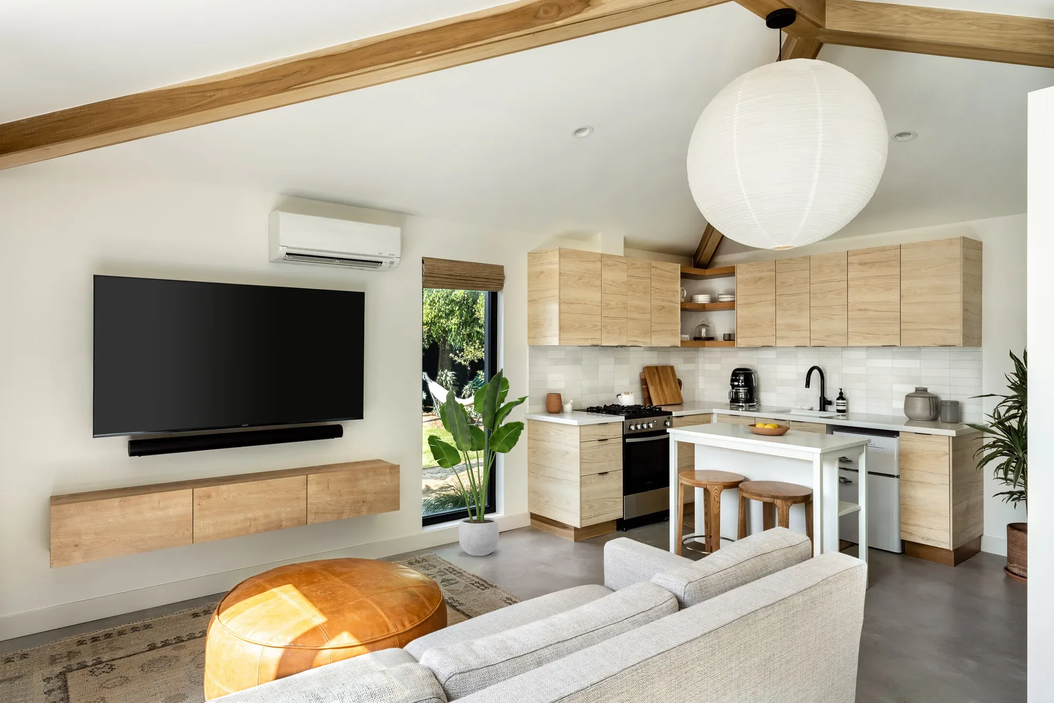 3712-Muirfield-05-Plant A kitchen and living room in a tiny house.